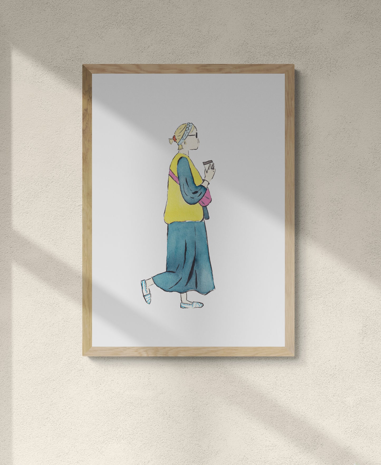 Framed artwork of a girl walking with coffee in hand in a cute spring outfit of long denim dress with yellow vest pink bag and white and blue shoes with blue headband and orange scrunchie