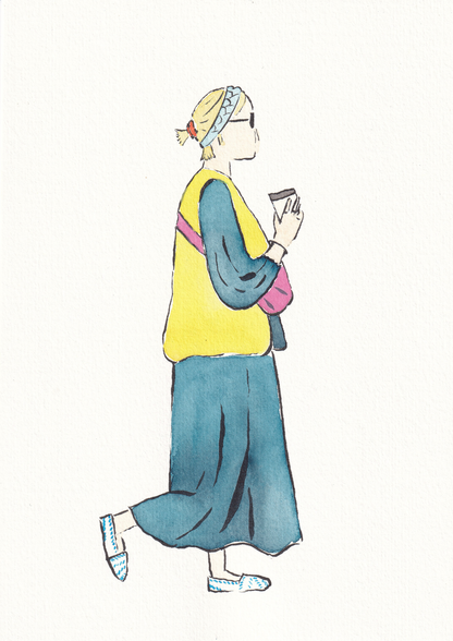 Girl walking with coffee in hand in a cute spring outfit of long denim dress with yellow vest pink bag and white and blue shoes with blue headband and orange scrunchie