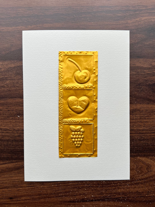 A5 paper featuring a vertical gold foil design with embossed fruit motifs, a cherry, a heart, and a raspberry