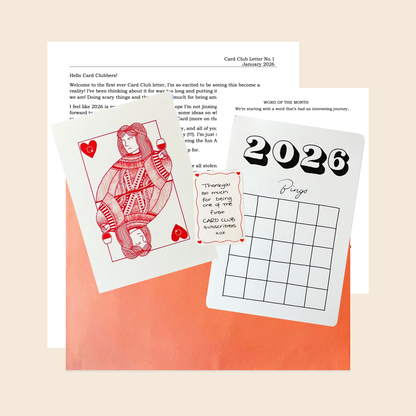 a flat lay of January print club gift greeting card queen of hearts bingo card 2026 thank you note and premium packaging affordable art