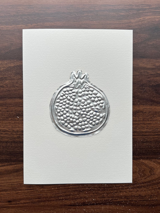 A5 paper featuring a detailed embossed pomegranate design in the centre