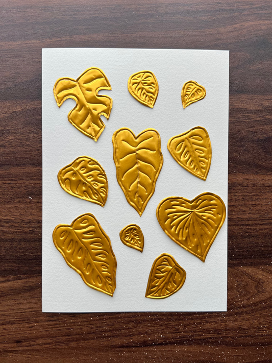 A5 paper featuring embossed metallic gold leaf-shaped designs