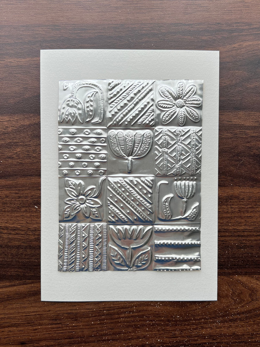 A5 paper featuring a 3x4 grid of embossed metallic silver textures, including floral, geometric, and leaf patterns