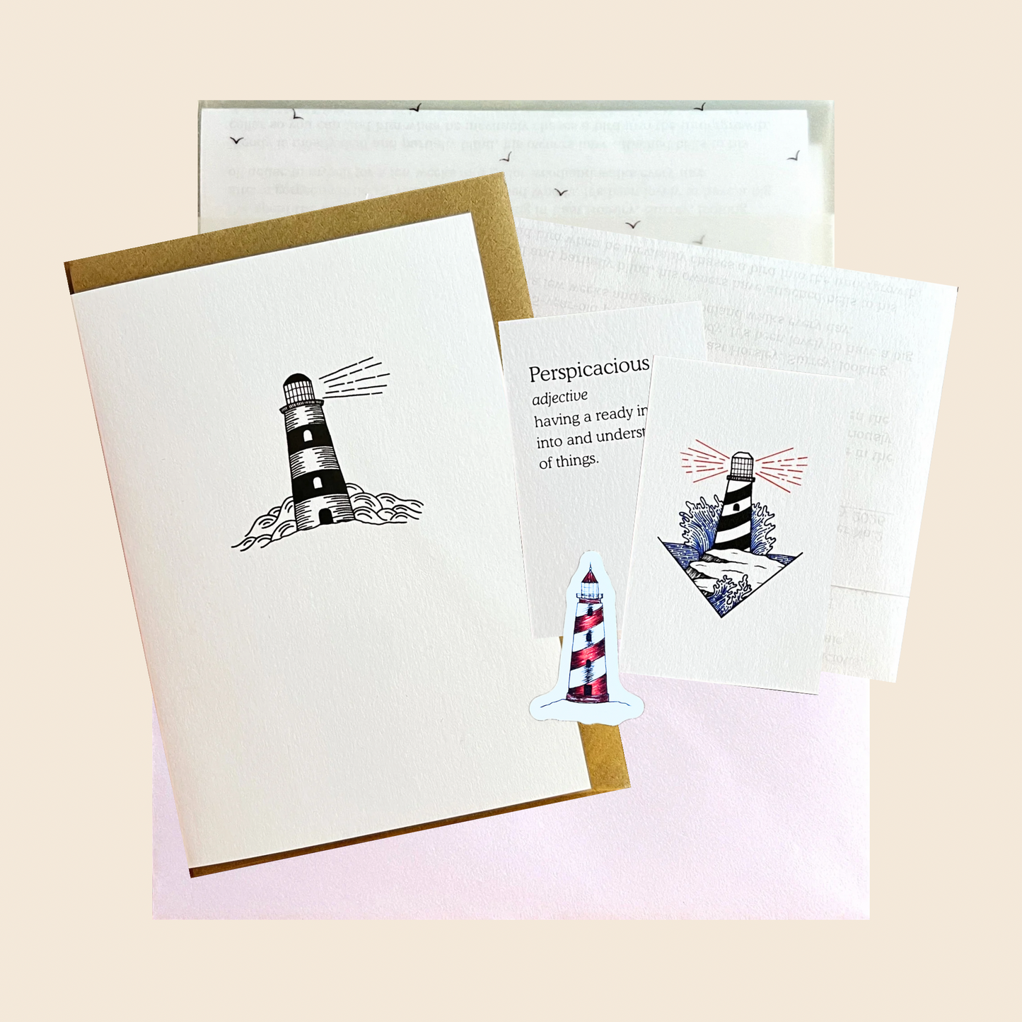 a flat lay of February print club greeting card lighthouse sticker mini print word of the month letter and premium packaging affordable art